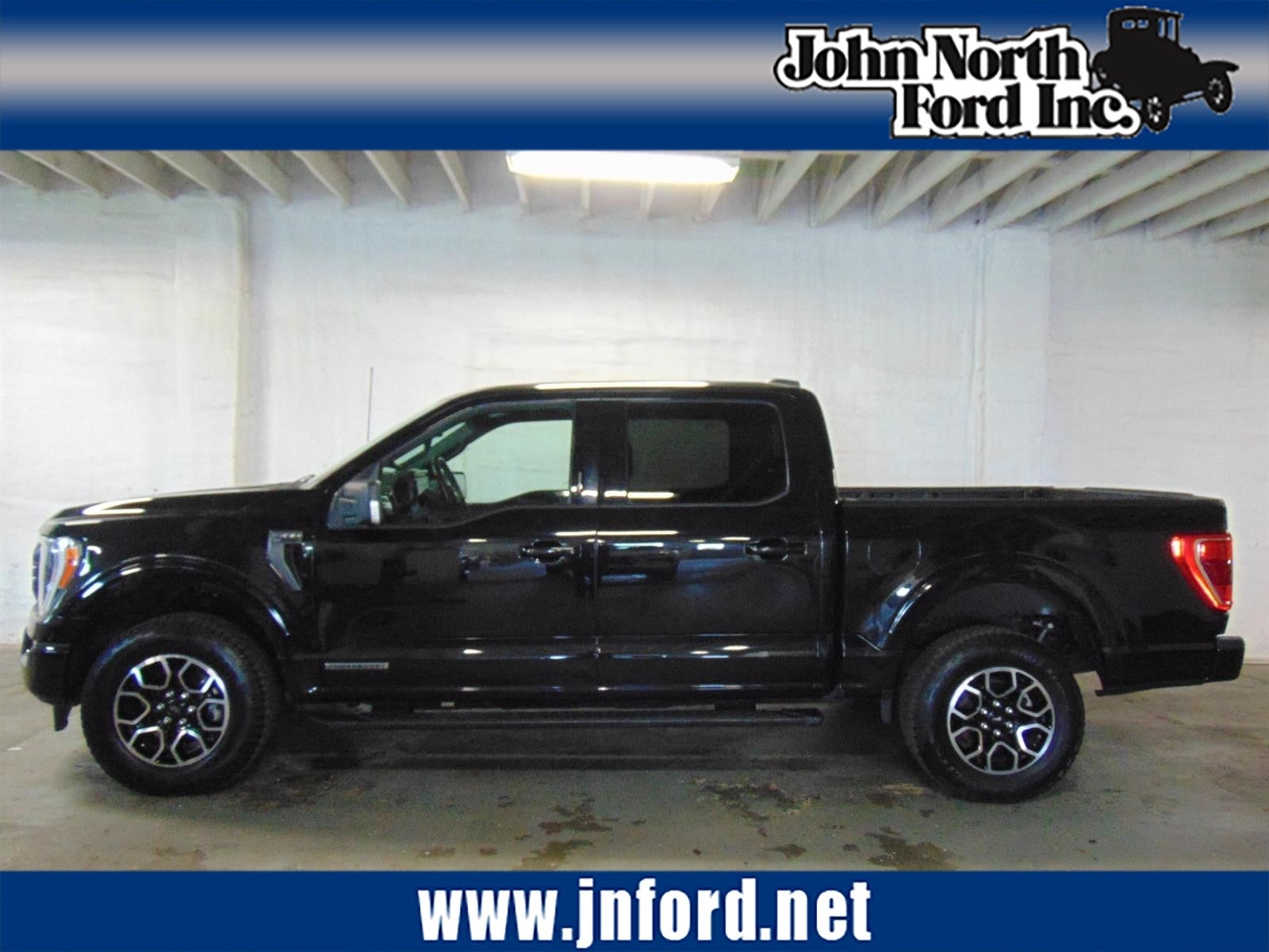 2023 Ford F-150 XLT in Agate Black (Um) — front three-quarter view